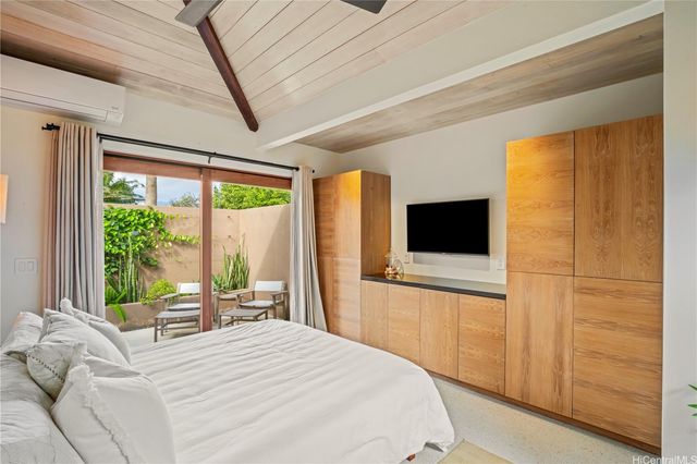 a bedroom with a bed and a television