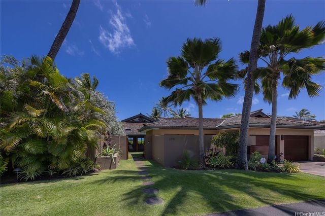 a view of a palm trees in front of a house