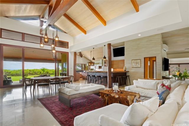 a living room with fireplace furniture and a large window