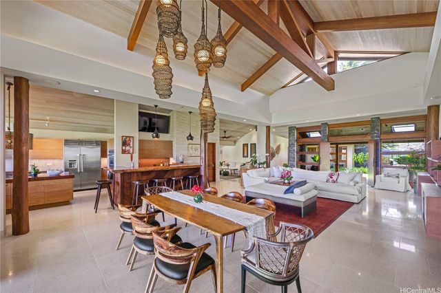 a dining room with furniture a chandelier and wooden floor