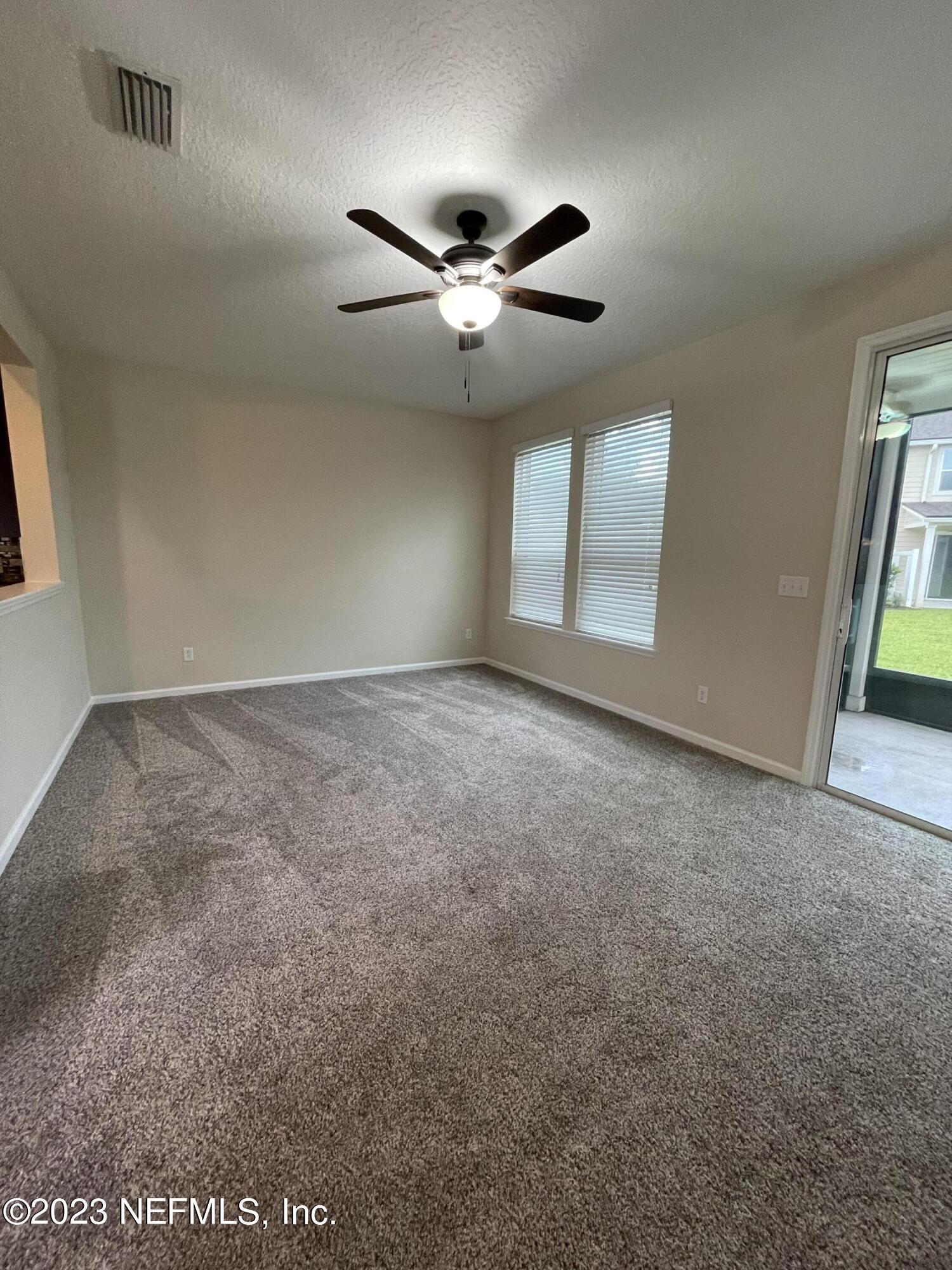 41 Nelson Lane St. Johns, FL 32259 - Photo 2 of 18 an empty room with windows and fan