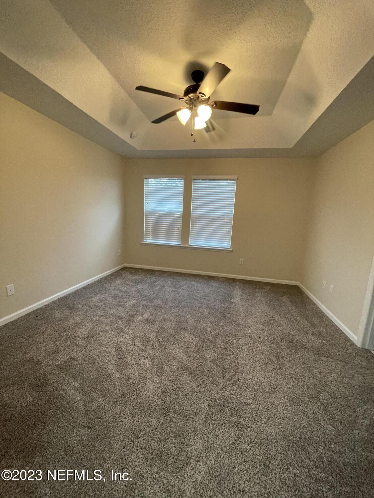 41 Nelson Lane St. Johns, FL 32259 - Photo 10 of 18 an empty room with windows and fan