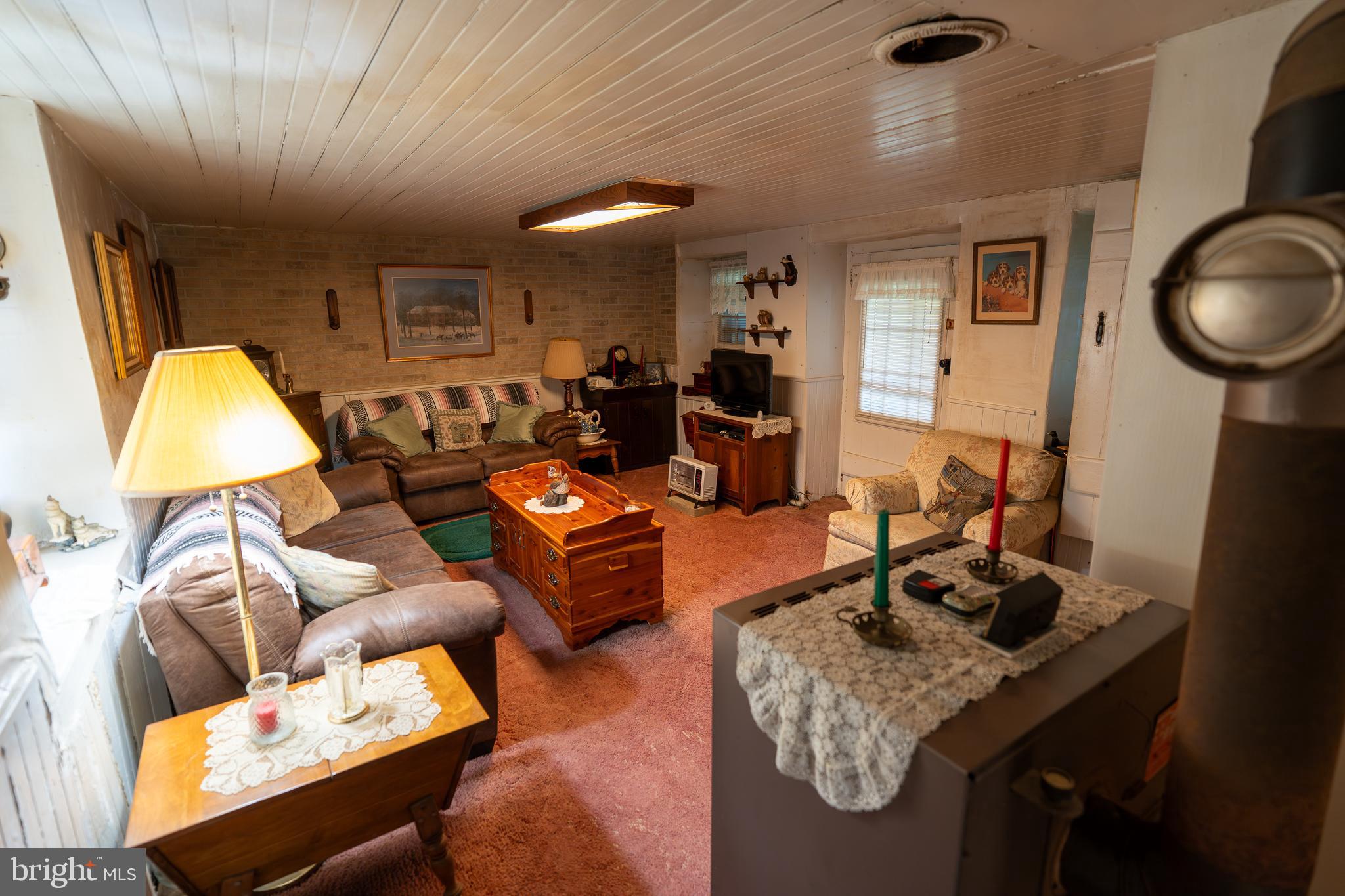 4520 Newark Road Cochranville, PA 19330 - Photo 2 of 24 a living room with furniture and a lamp