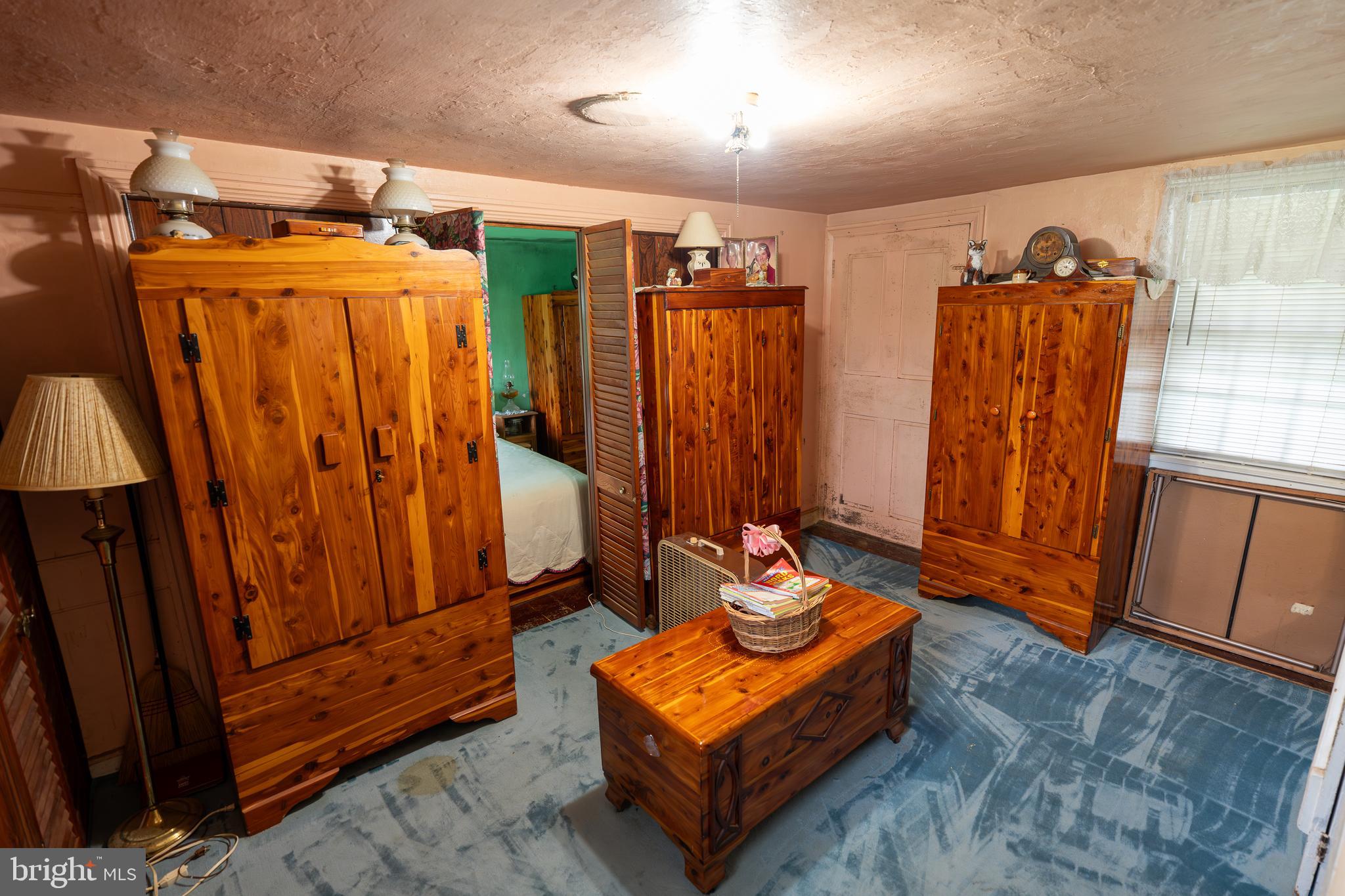 4520 Newark Road Cochranville, PA 19330 - Photo 10 of 24 a blue bed sitting in a room next to a window