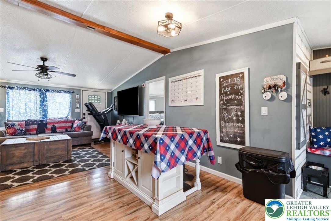 634 Main Road Lehighton, PA 18235 - Photo 12 of 39 Hardwood flooring extends throughout this inviting living space, complementing a convenient kitchen island and vaulted ceilings.