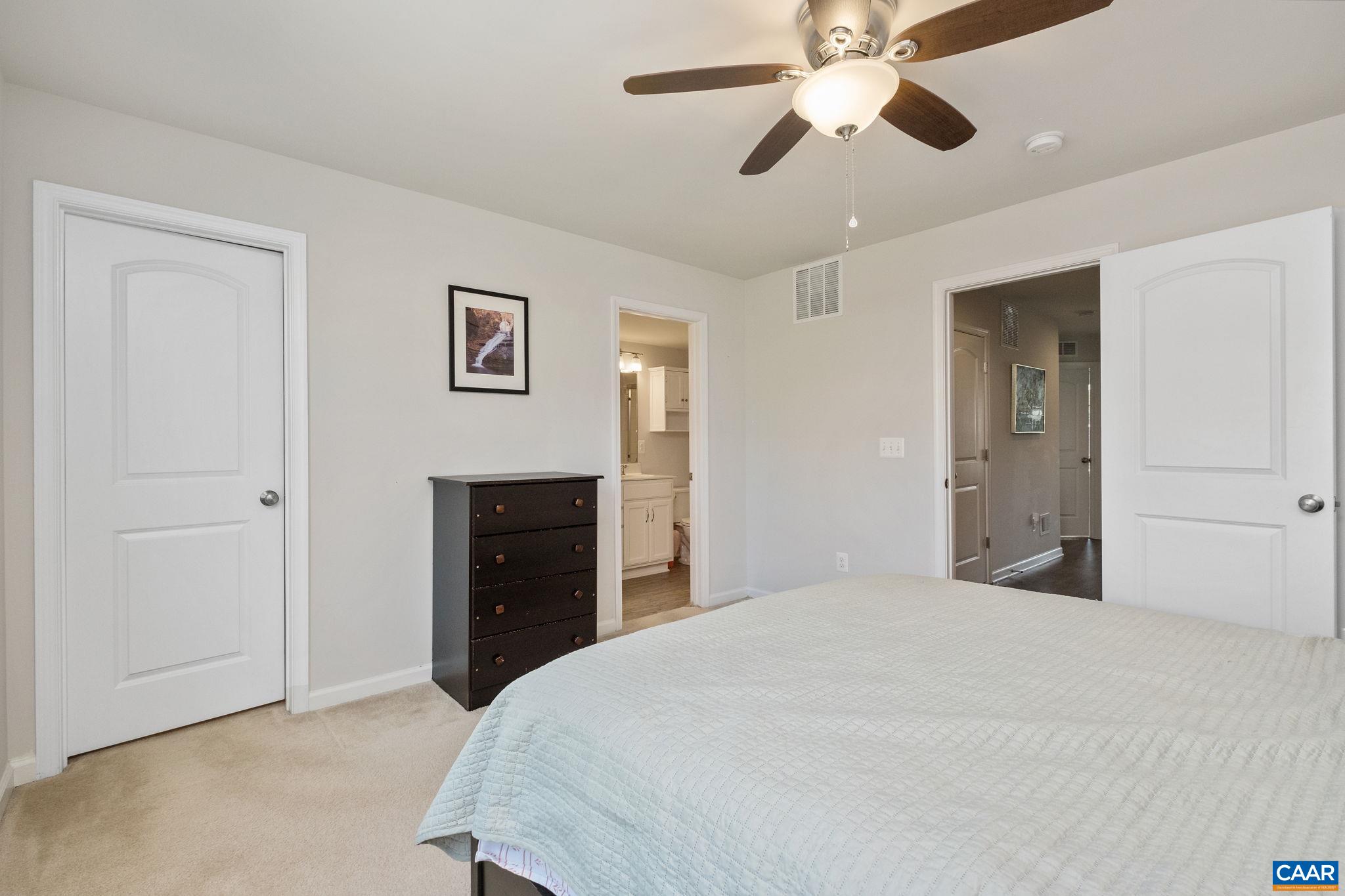 2720 Avinity Lane Charlottesville, VA 22902 - Photo 15 of 45 a spacious bedroom with a bed and a chandelier