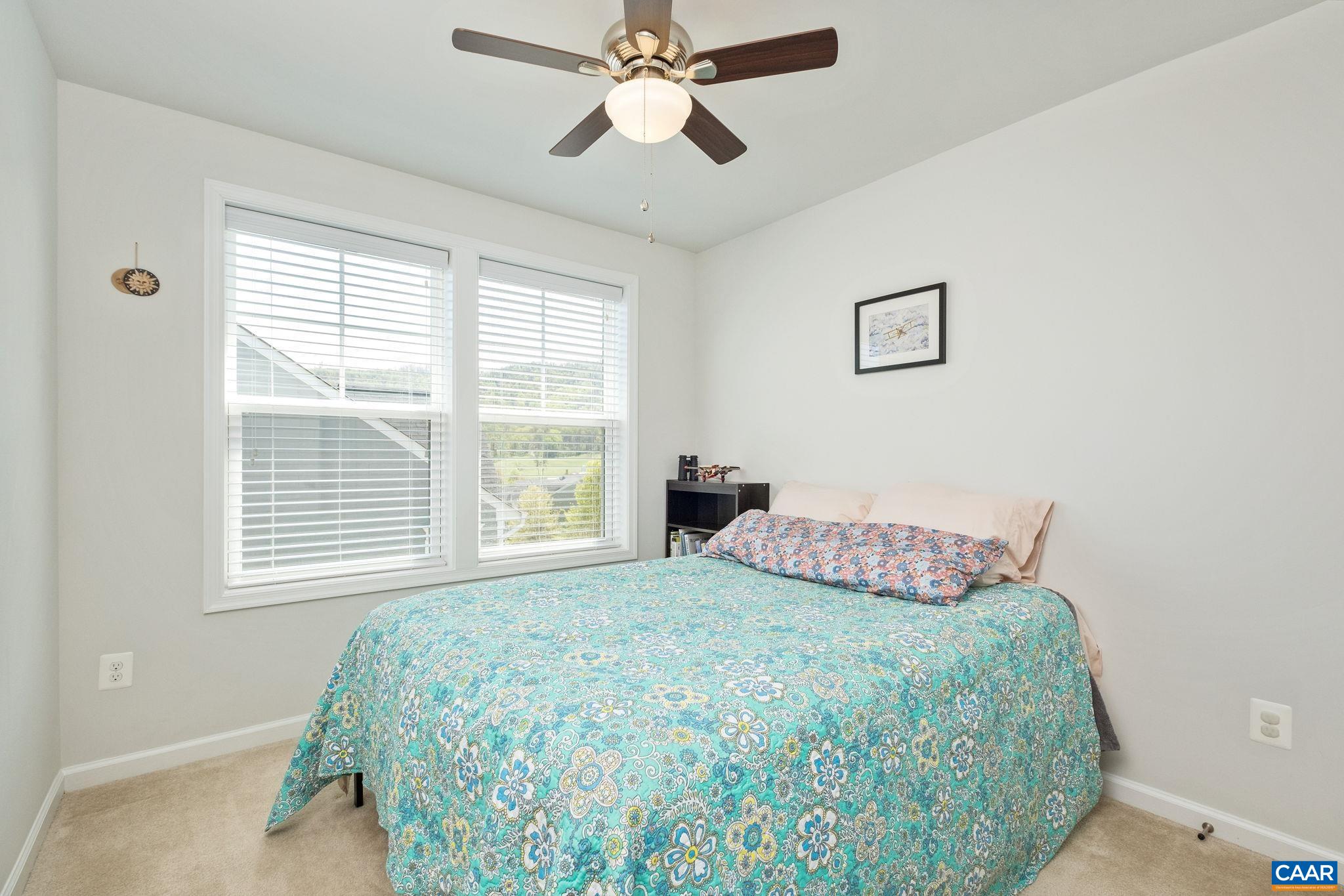 2720 Avinity Lane Charlottesville, VA 22902 - Photo 17 of 45 a bedroom with a bed and a chandelier