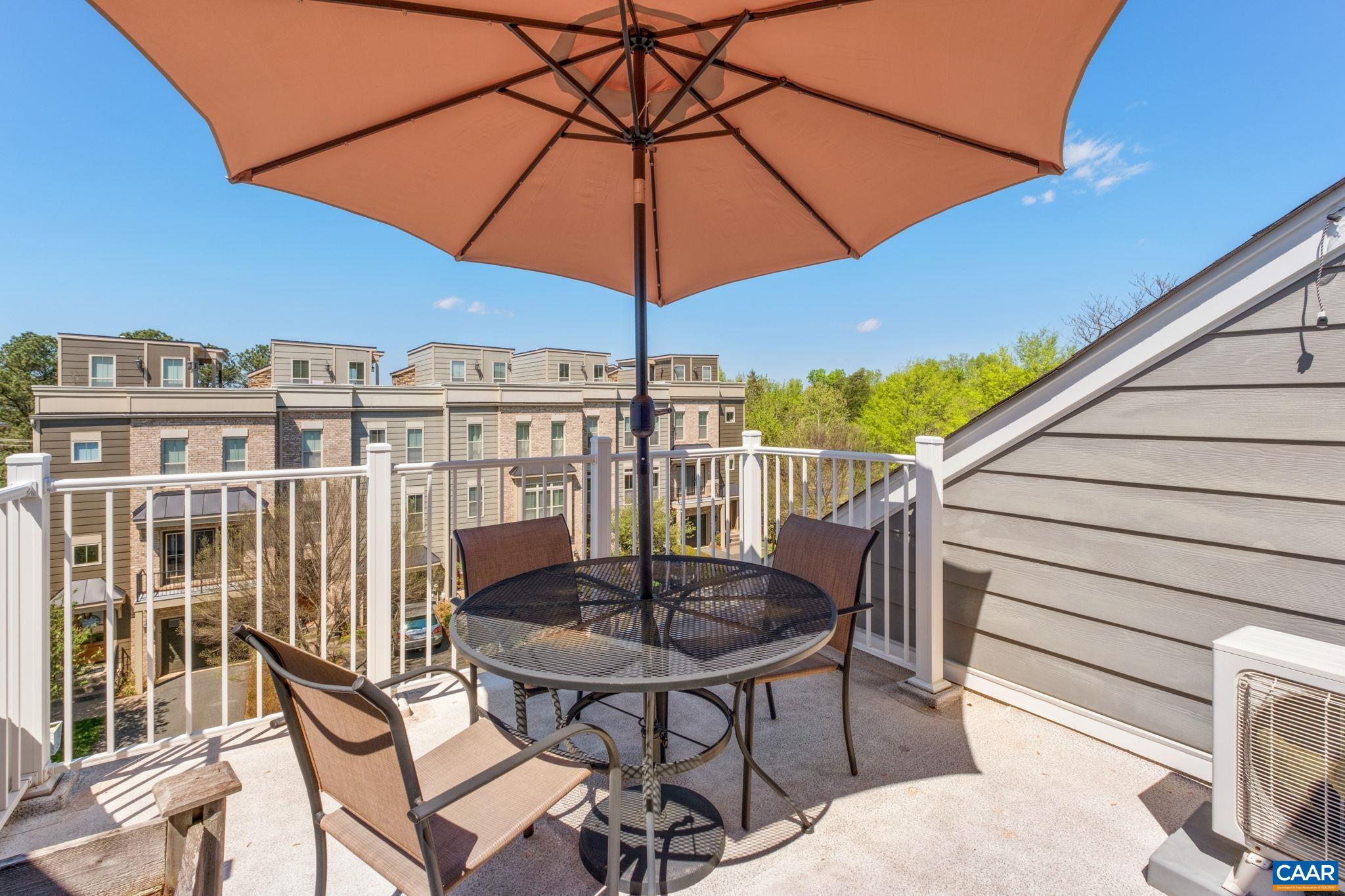 2720 Avinity Lane Charlottesville, VA 22902 - Photo 24 of 45 a view of a patio with a table and chairs under an umbrella