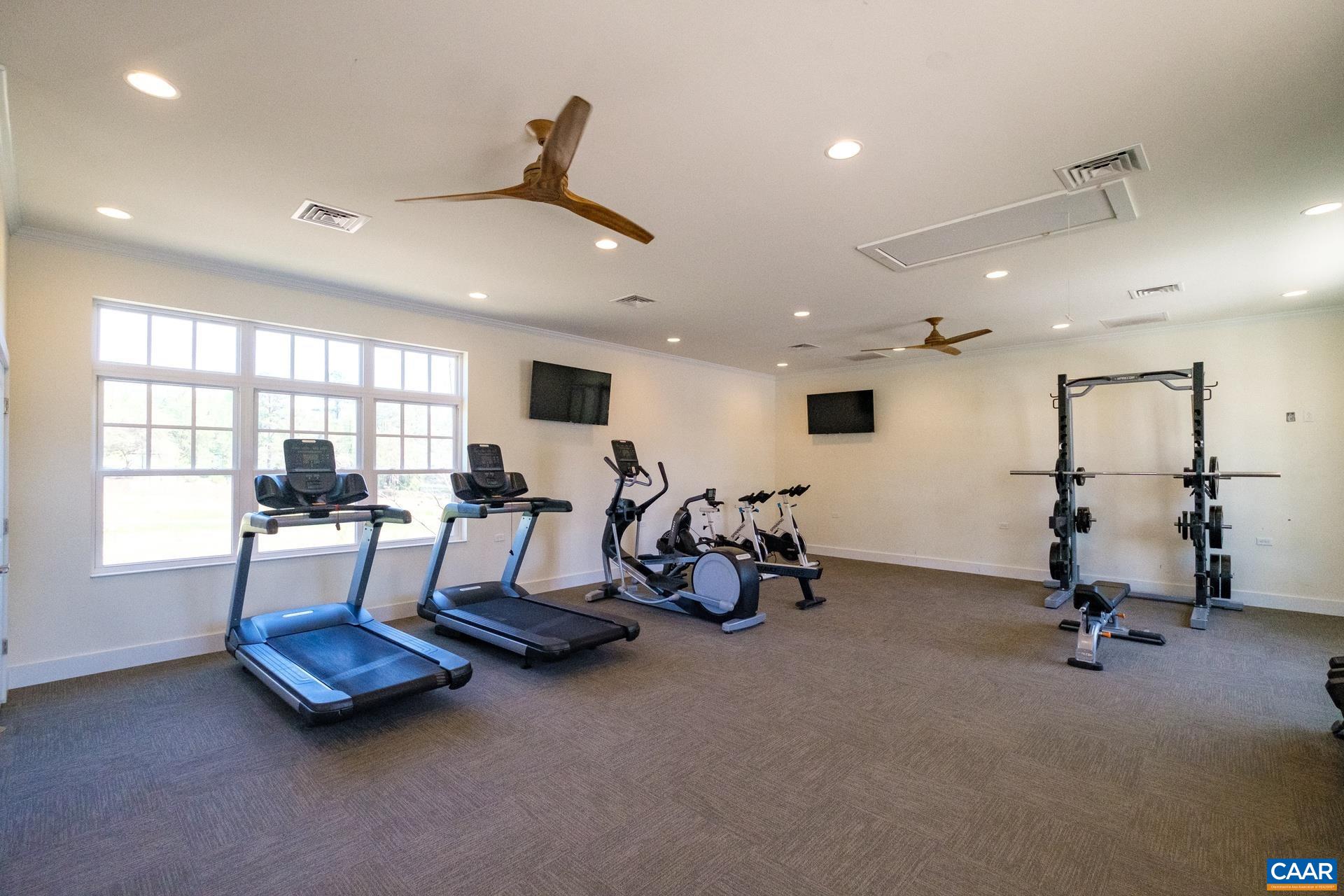 2720 Avinity Lane Charlottesville, VA 22902 - Photo 36 of 45 a living room with gym equipment and a large window