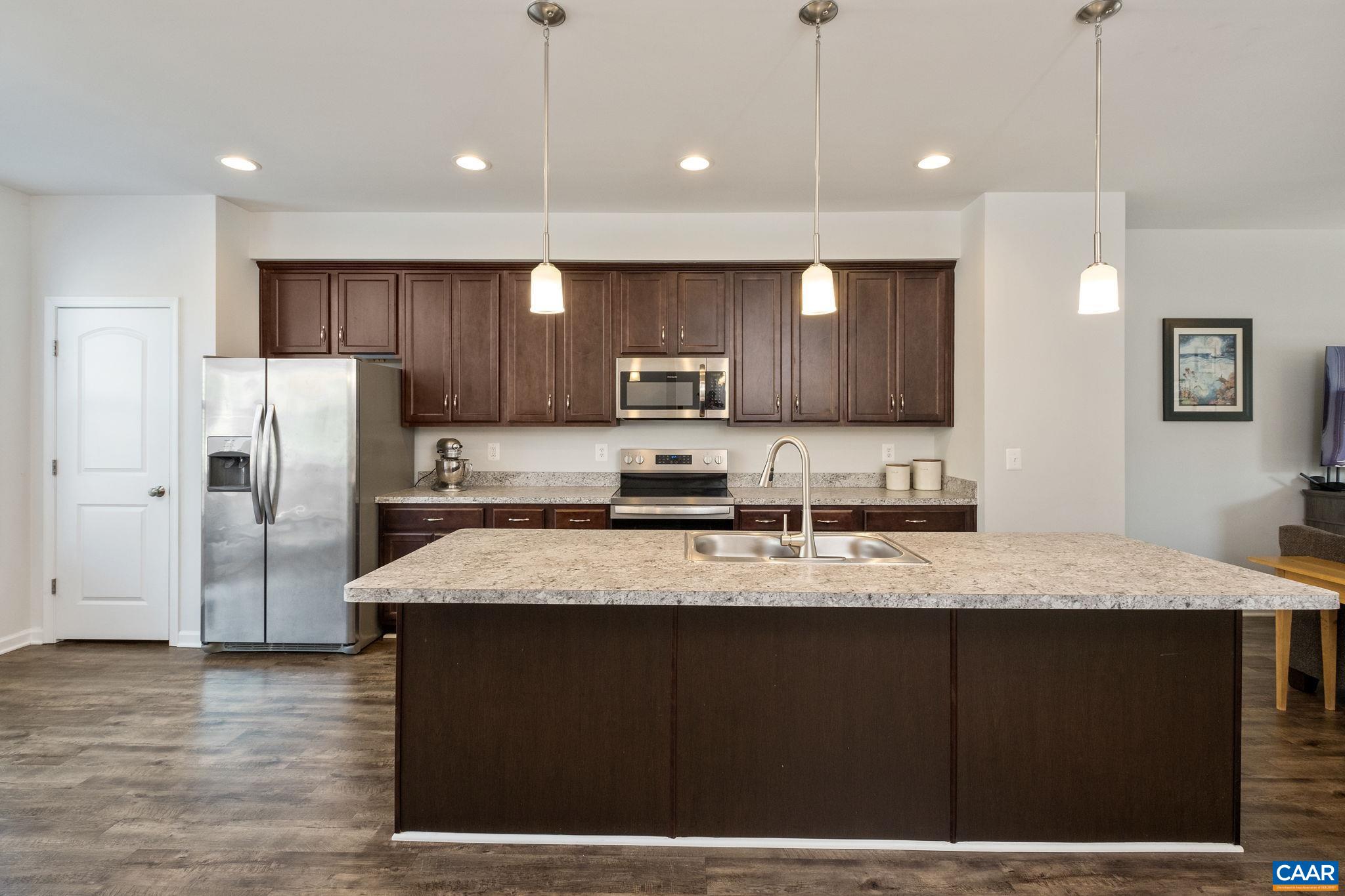 2720 Avinity Lane Charlottesville, VA 22902 - Photo 8 of 45 a large kitchen with stainless steel appliances kitchen island granite countertop a refrigerator a sink a stove a microwave and wooden cabinets