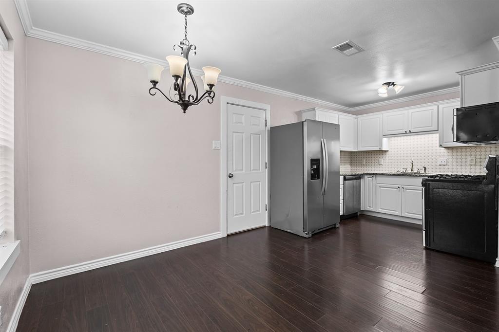 1135 Reed Circle Howe, TX 75459 - Photo 10 of 28 a kitchen with stainless steel appliances granite countertop white cabinets a refrigerator a sink a stove a microwave and wooden floor