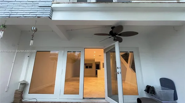 a view of a room with wooden floor and a balcony