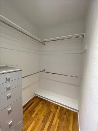 a view of an empty room and wooden floor