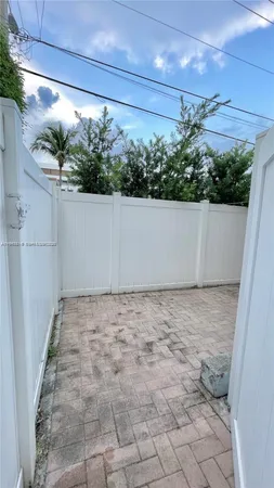 a view of a backyard with potted plants