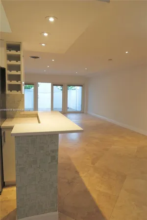 a kitchen sink with a stove next to a window