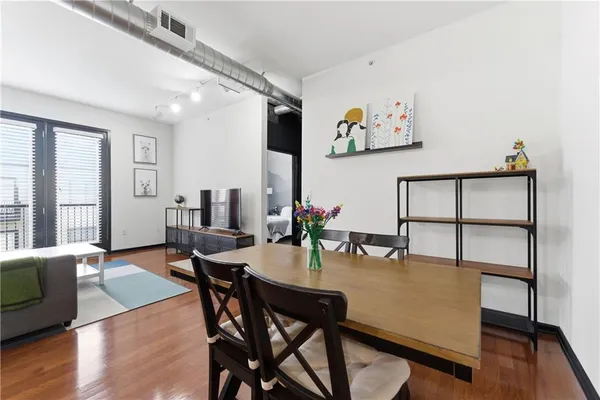 a view of a dining room with furniture and wooden floor