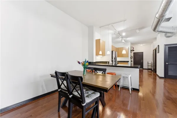 a dining room with furniture and wooden floor