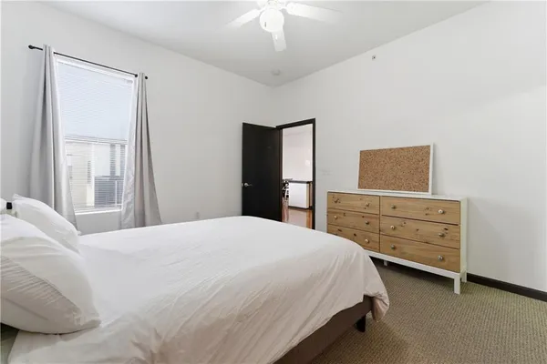 a bedroom with a bed and a dresser