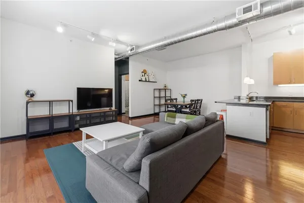 a living room with furniture and a flat screen tv