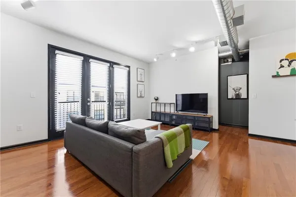 a living room with furniture and a flat screen tv