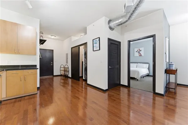 a view of a hallway with wooden floor and furniture