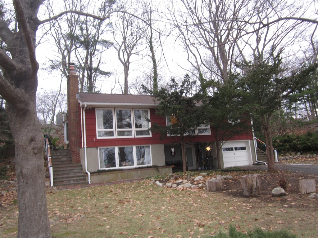 83 Hesperus Circle Gloucester, MA 01930 - Photo 2 of 17 a front view of a house with a yard and garage