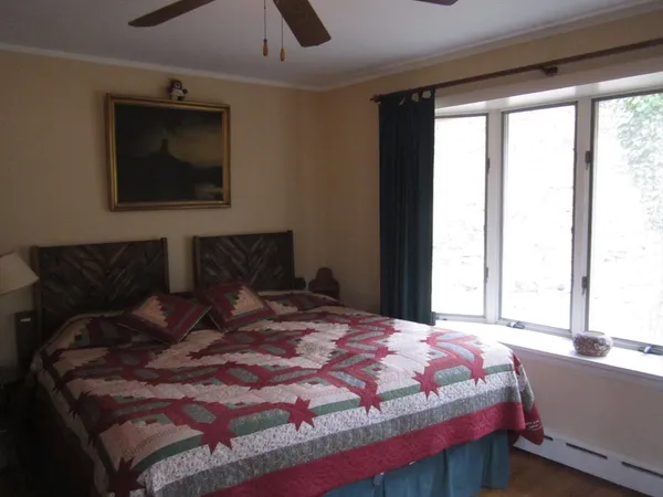 a bed sitting in a bedroom next to a window