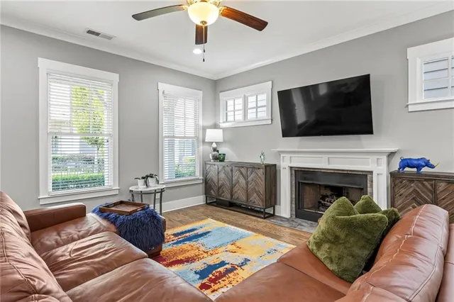 a living room with furniture a fireplace and a flat screen tv