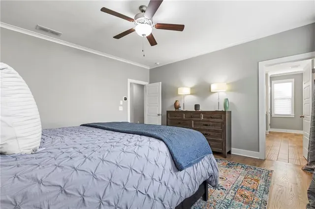 a spacious bedroom with a large bed and a chandelier