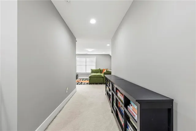 a hallway with a couch and a potted plant