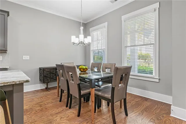 a view of a dining room with furniture and wooden floor