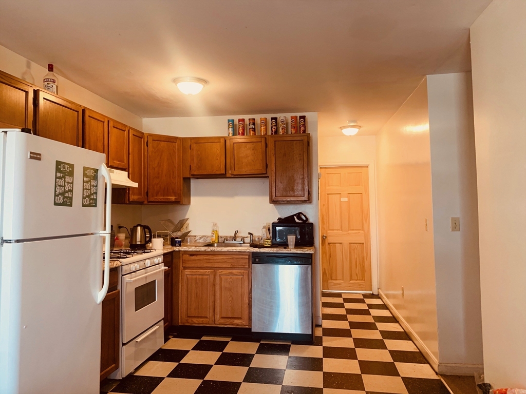 96 Hammond Street, Unit 4 Boston, MA 02120 - Photo 3 of 10 a kitchen with a white stove top oven and sink