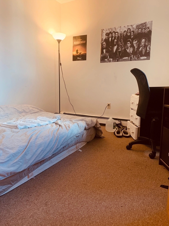 96 Hammond Street, Unit 4 Boston, MA 02120 - Photo 8 of 10 a room with a bed and furniture