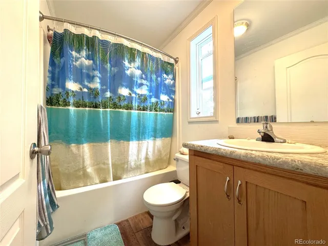 a bathroom with a granite countertop sink toilet and tub