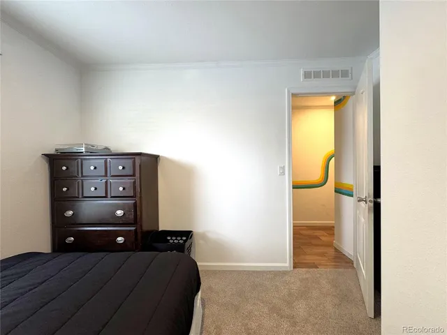 a view of a bedroom with a bed and couch
