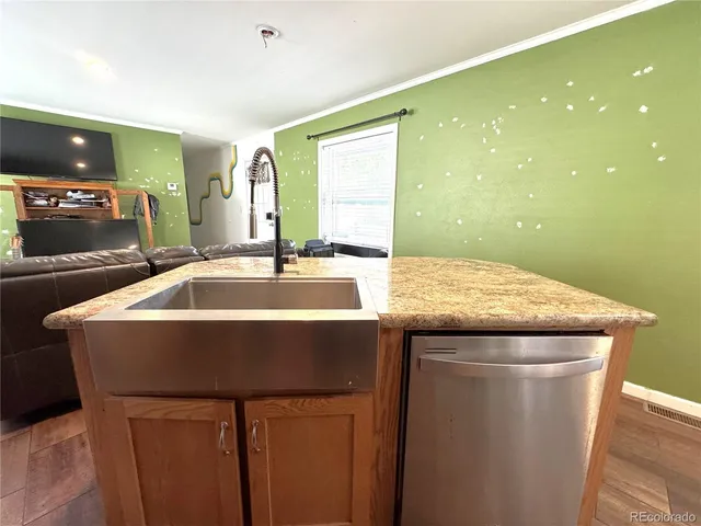 a kitchen with granite countertop a sink and a stove