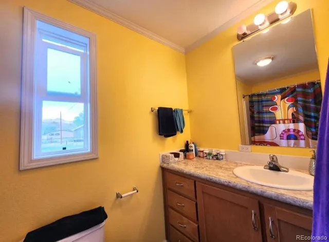 a bathroom with a granite countertop sink mirror and vanity
