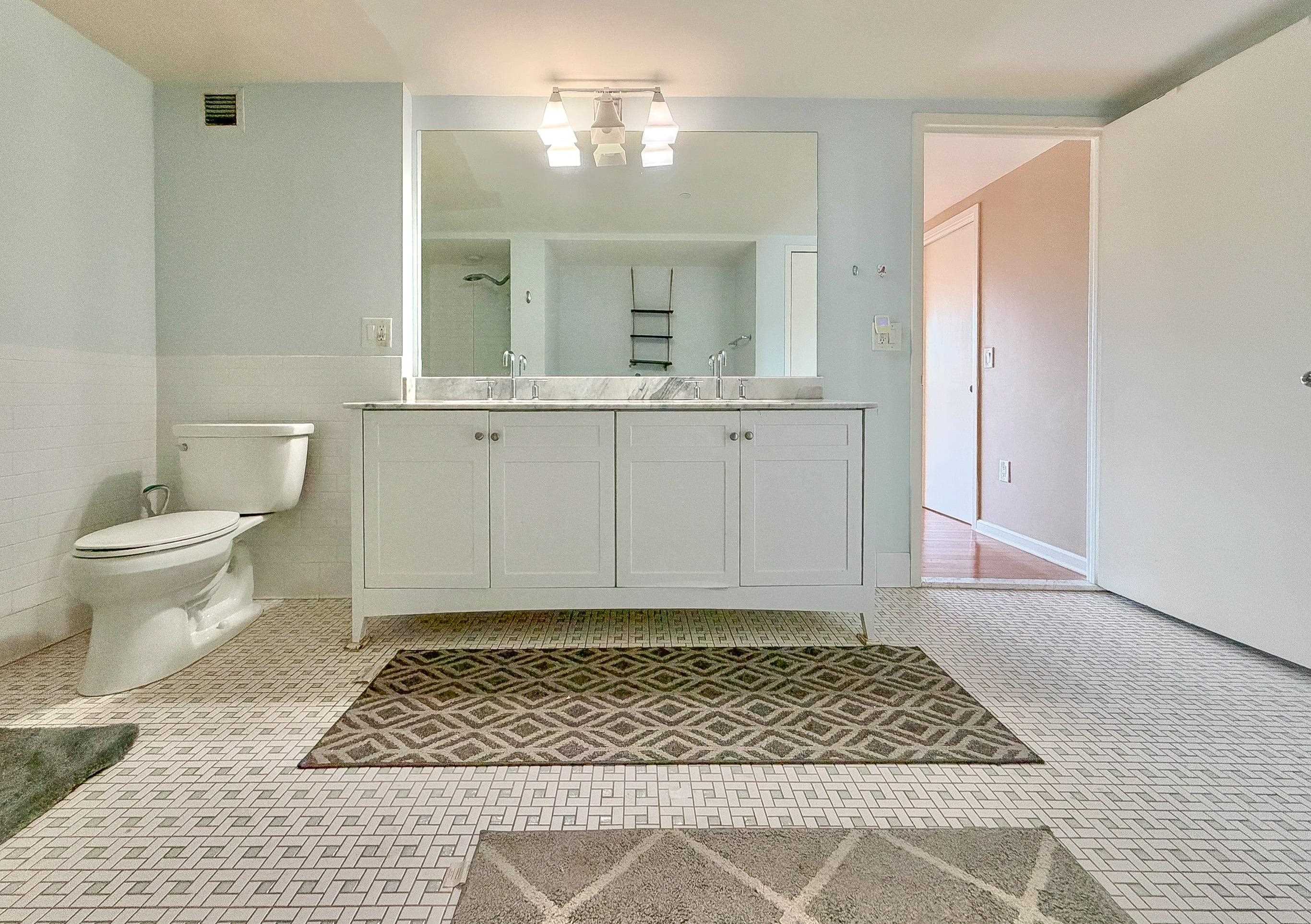 700 Grove Street, Unit 4F Jersey City, NJ 07310 - Photo 24 of 30 a bathroom with a sink a toilet and a mirror