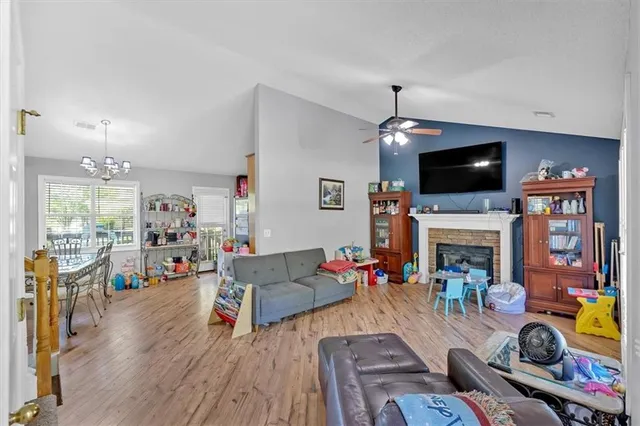 a living room with fireplace furniture and a flat screen tv