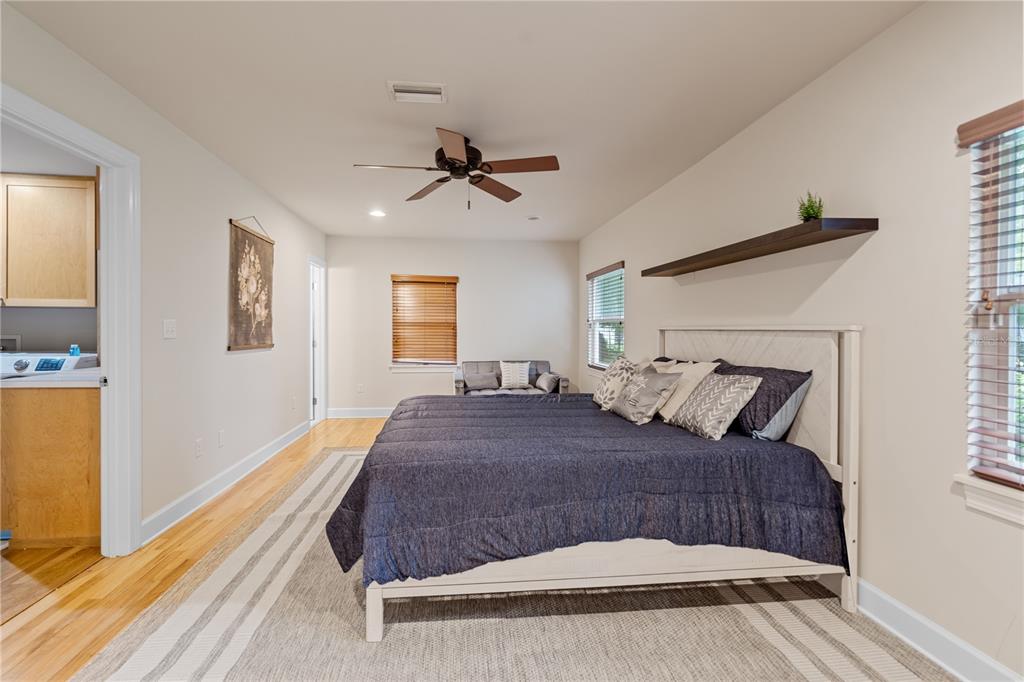 1017 Northeast 3rd Avenue Gainesville, FL 32601 - Photo 22 of 27 a bedroom with a large bed and a chandelier