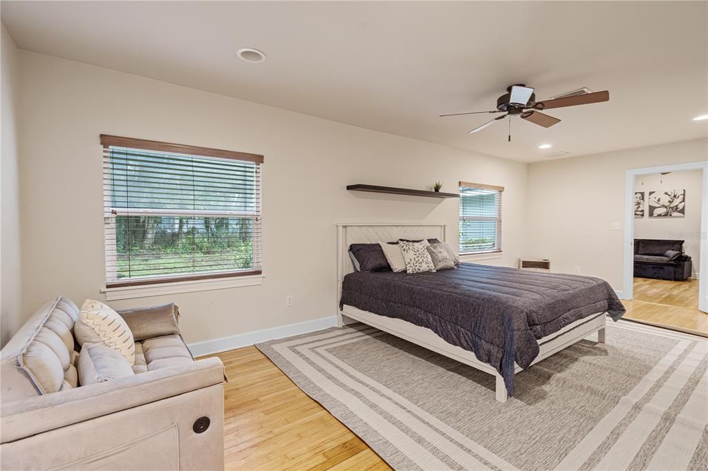 1017 Northeast 3rd Avenue Gainesville, FL 32601 - Photo 23 of 27 a bedroom with a large bed and a couch