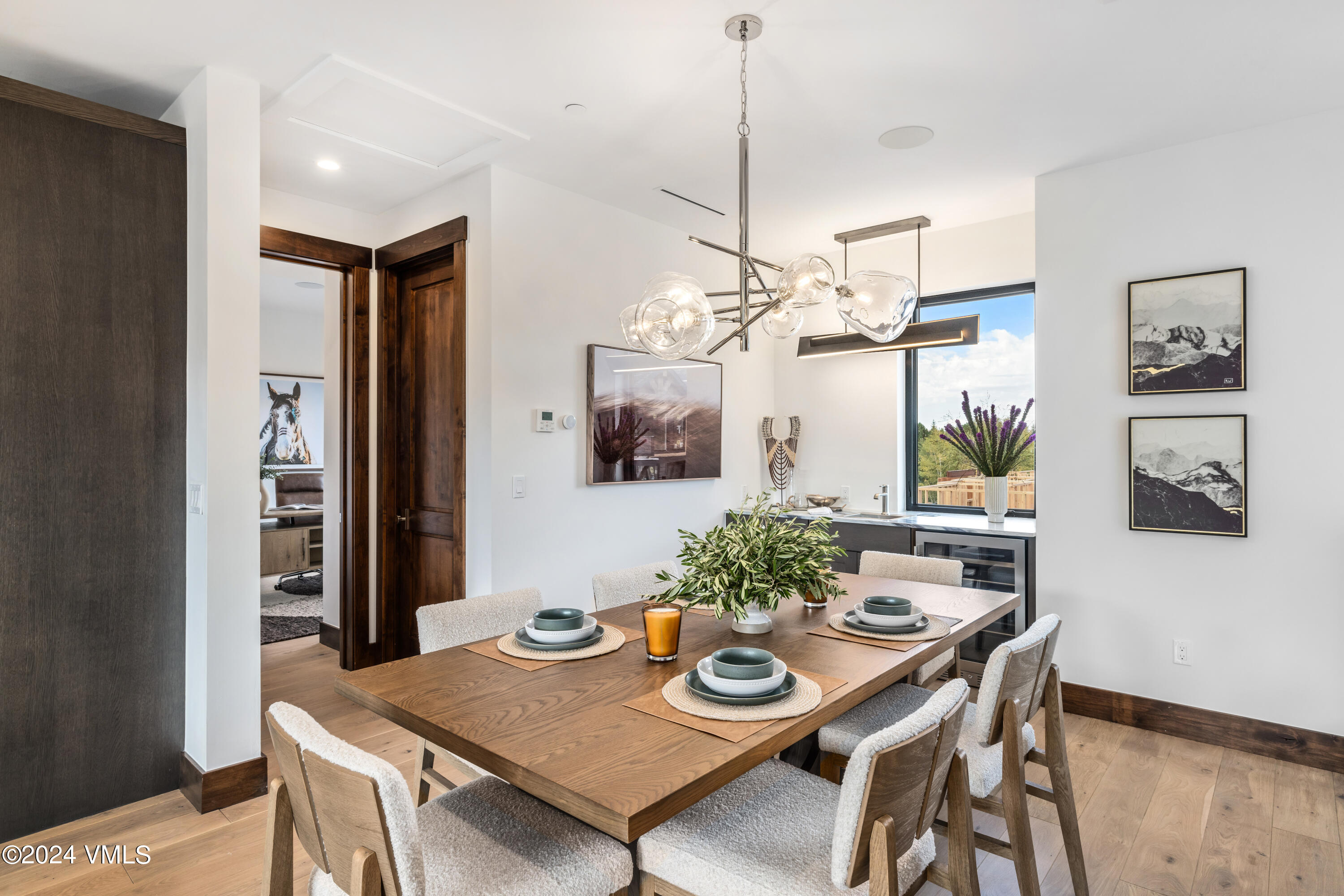 100 Goldfinch Lane, Unit 2B Avon, CO 81620 - Photo 19 of 47 a view of a dining room with furniture and chandelier