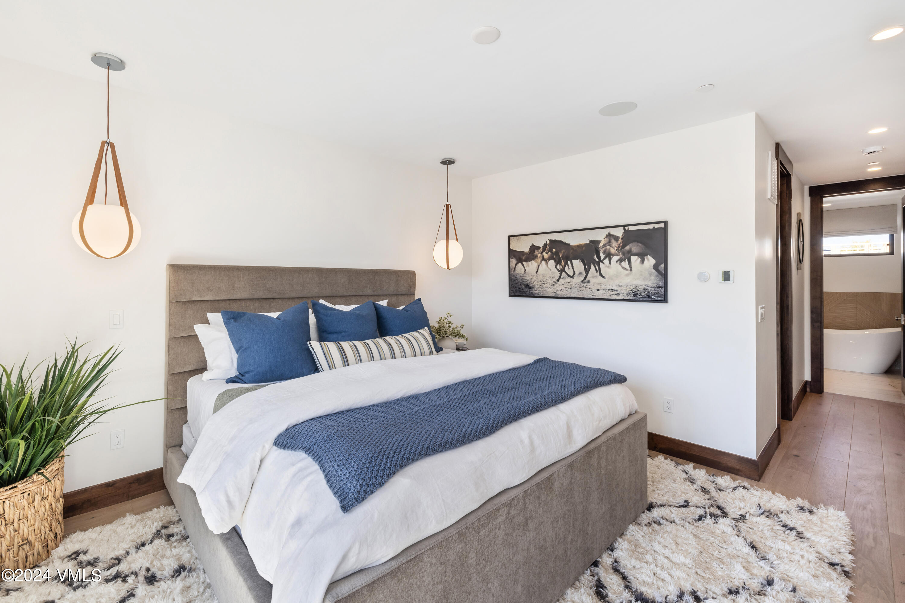 100 Goldfinch Lane, Unit 2B Avon, CO 81620 - Photo 23 of 47 a bedroom with bed and wooden floor