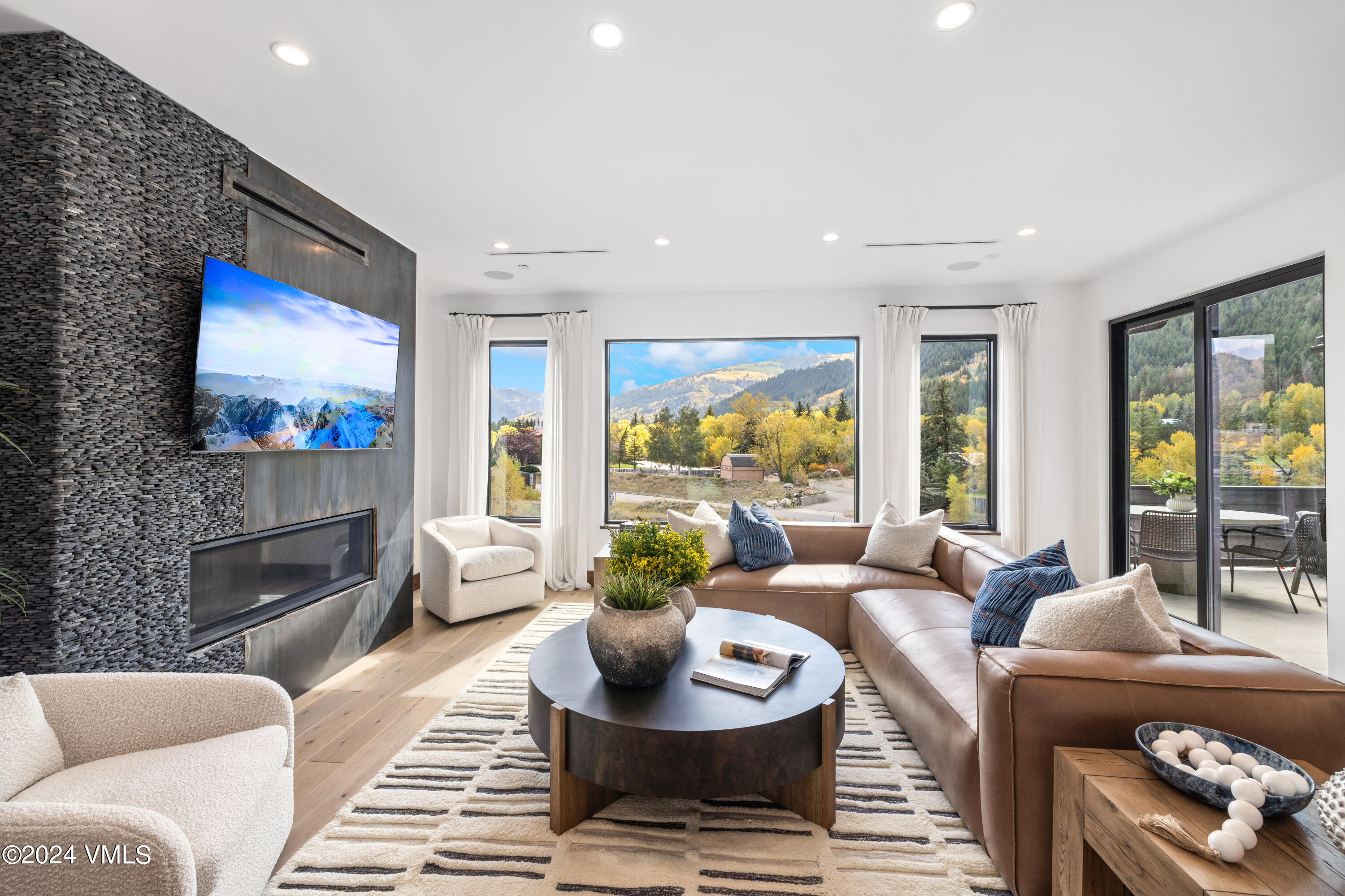 100 Goldfinch Lane, Unit 2B Avon, CO 81620 - Photo 3 of 47 a living room with fireplace furniture and a flat screen tv