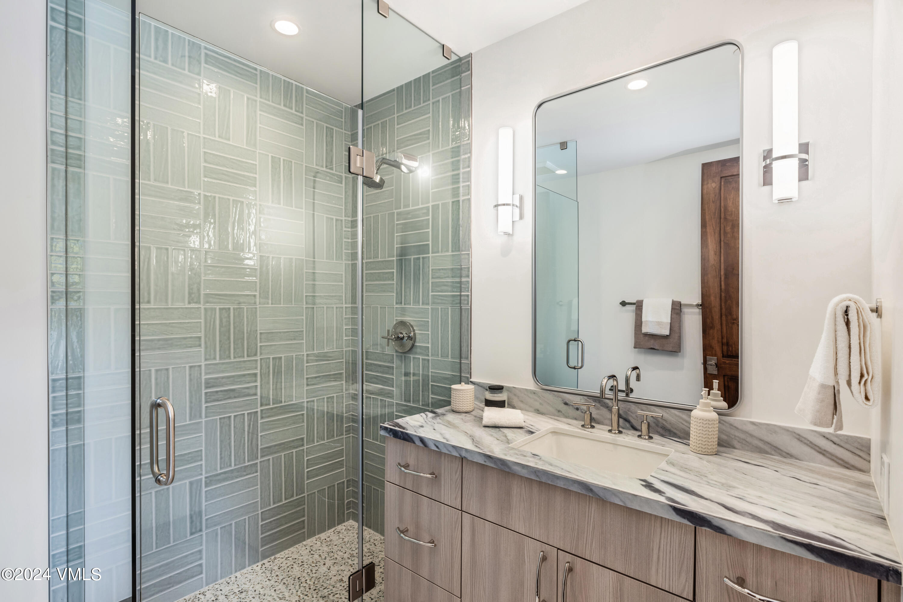 100 Goldfinch Lane, Unit 2B Avon, CO 81620 - Photo 38 of 47 a bathroom with a shower sink and mirror
