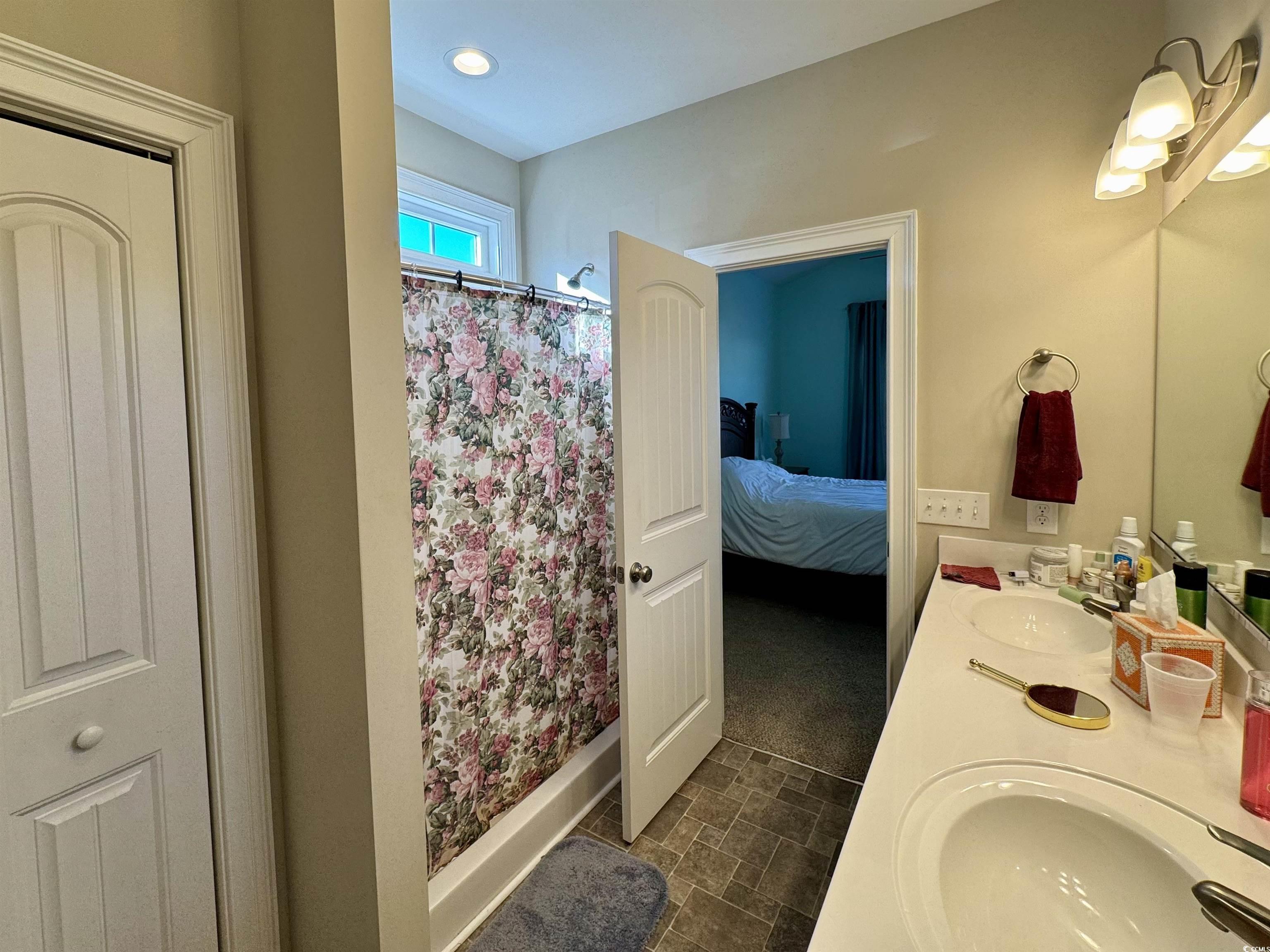 117 Baylee Circle Galivants Ferry, SC 29544 - Photo 12 of 17 Ensuite bathroom featuring double vanity and a shower with shower curtain