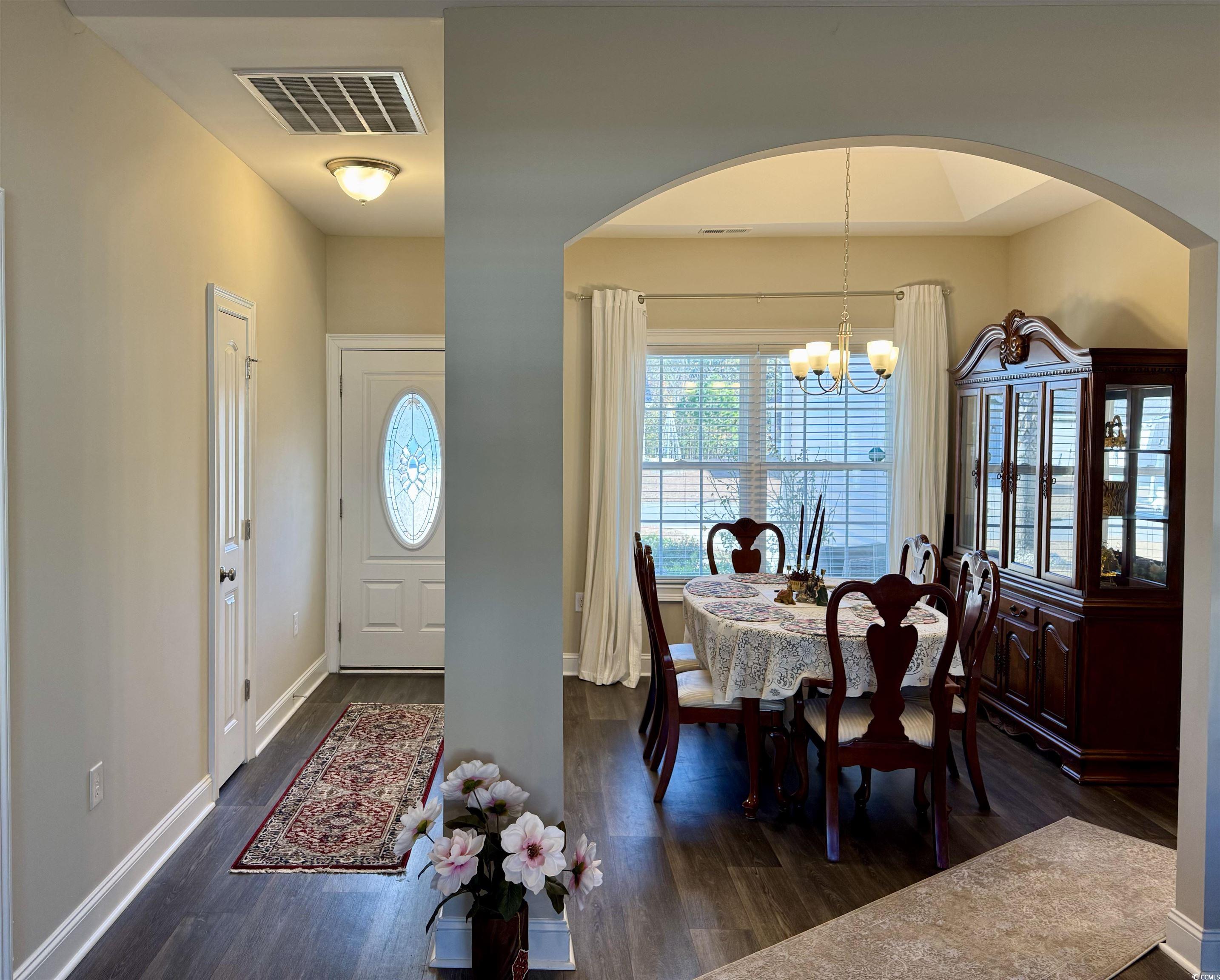 117 Baylee Circle Galivants Ferry, SC 29544 - Photo 3 of 17 Dining room with arched walkways, dark wood-style flooring, and a chandelier
