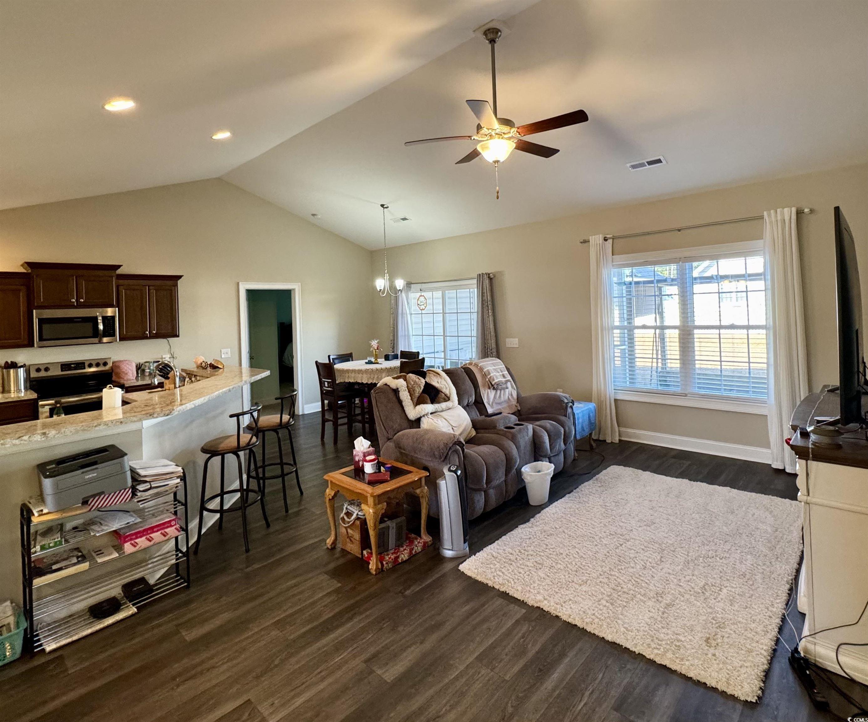 117 Baylee Circle Galivants Ferry, SC 29544 - Photo 4 of 17 Living area featuring vaulted ceiling, dark wood-style flooring, a ceiling fan, and a chandelier