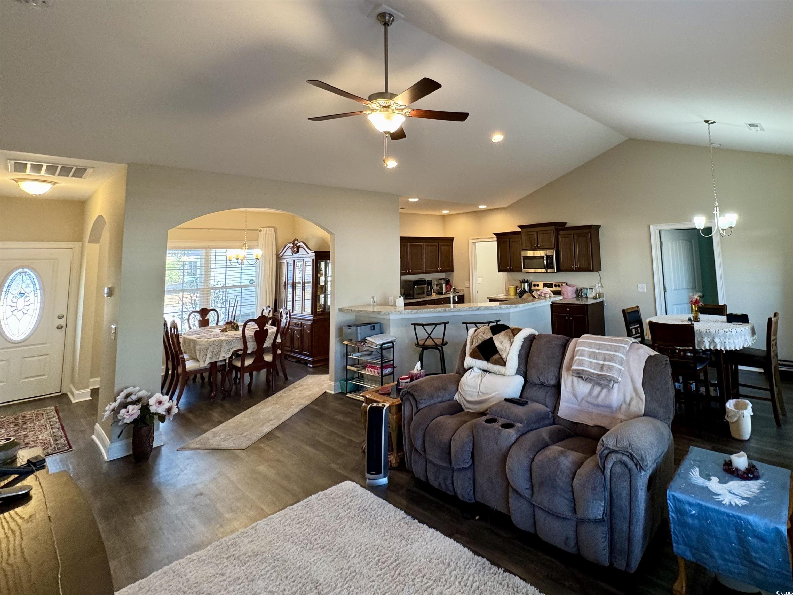 117 Baylee Circle Galivants Ferry, SC 29544 - Photo 5 of 17 Living room featuring a chandelier, arched walkways, lofted ceiling, and a ceiling fan