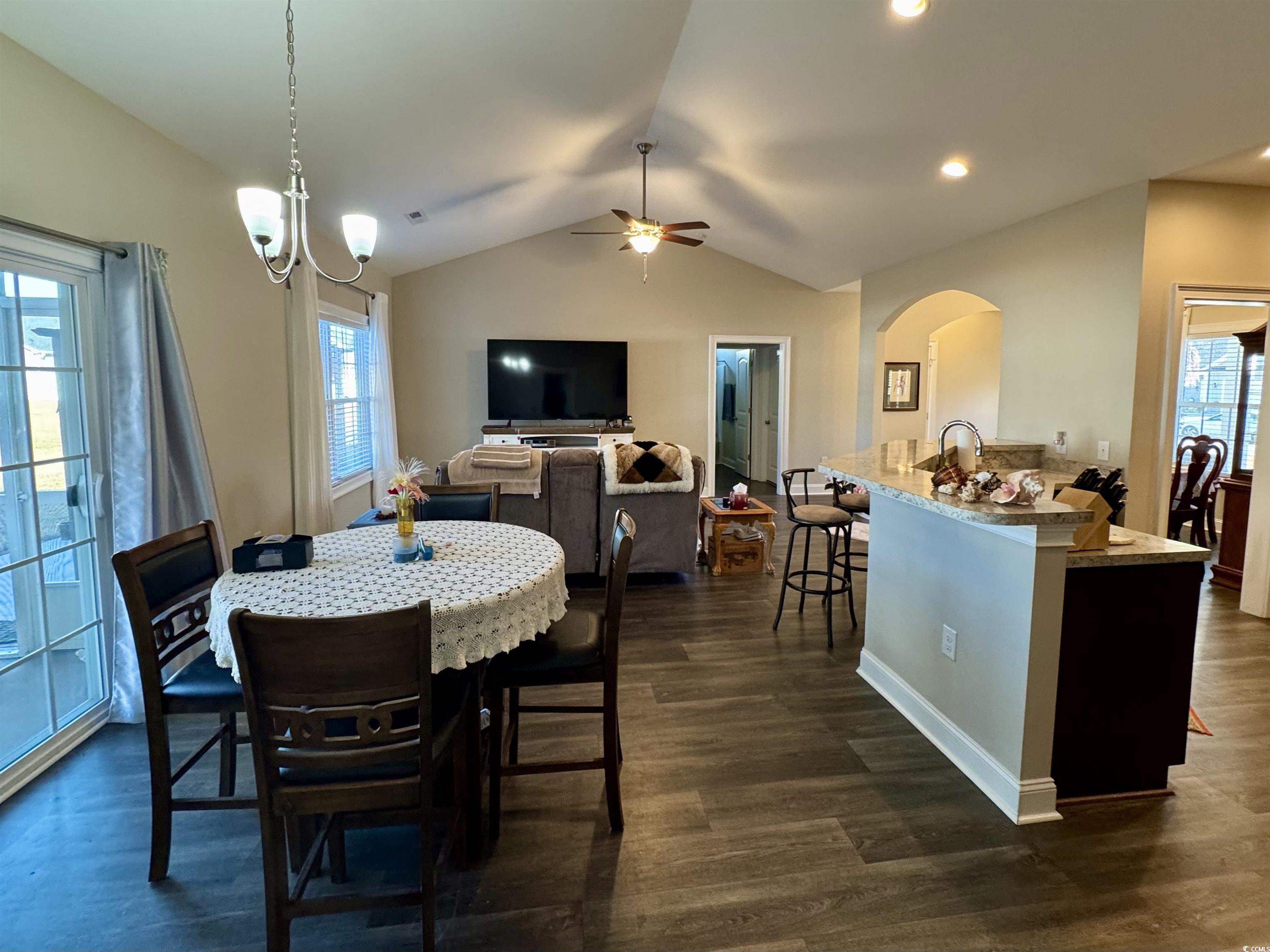 117 Baylee Circle Galivants Ferry, SC 29544 - Photo 7 of 17 Dining space with vaulted ceiling, a ceiling fan, dark wood-type flooring, and arched walkways